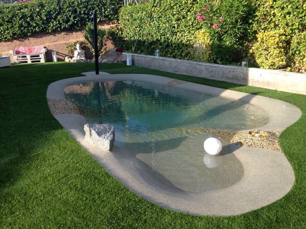 Piscina de forma libre con playa de arena